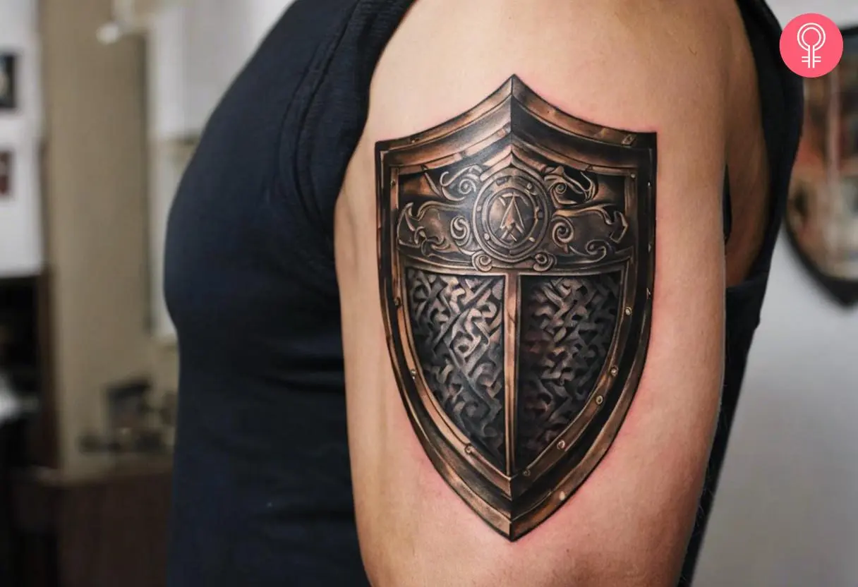 A man with a gladiator shield tattoo on his upper arm