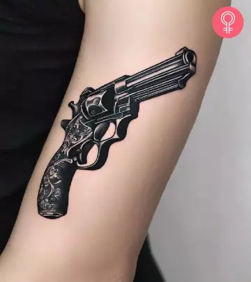 A woman with a glock tattoo on her upper arm
