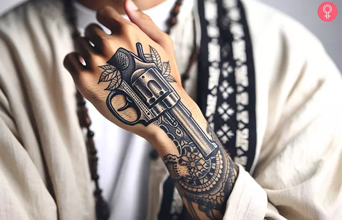 Gun tattoo on the back of the palm