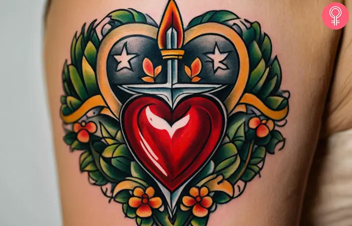 A woman with a heart and dagger tattoo on her upper arm