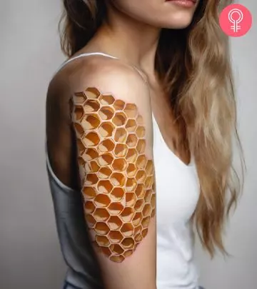 A fine line geometrical hexagon tattoo on the upper arm