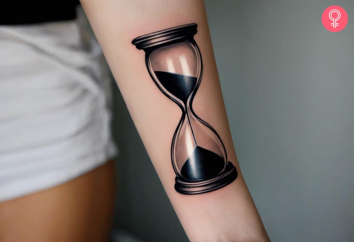 Hourglass tattoo on the forearm of a woman