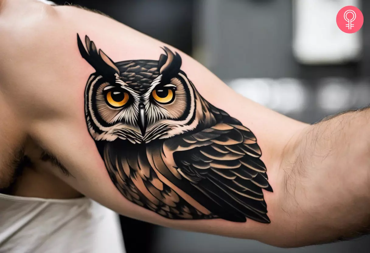 An eye-catching owl tattoo on the inner bicep