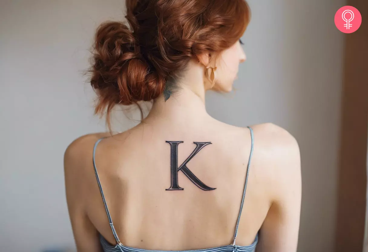 Letter K tattoo on the back