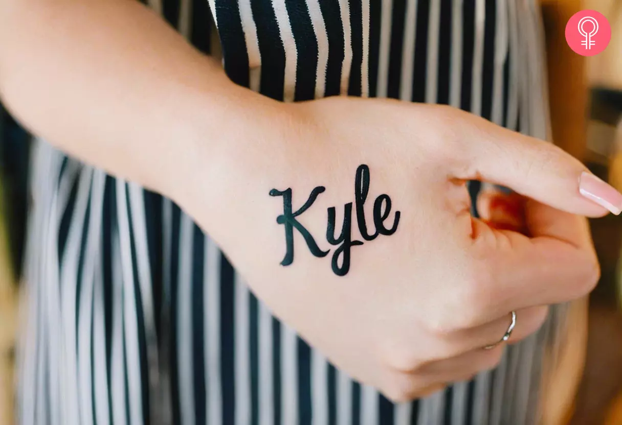 A name tattoo on the back of the hand