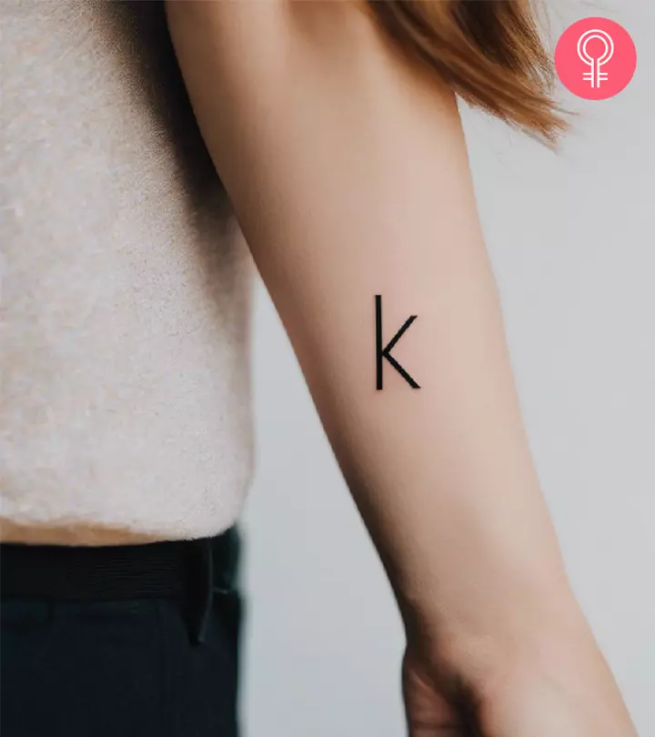 Letter K written in bold on the forearm