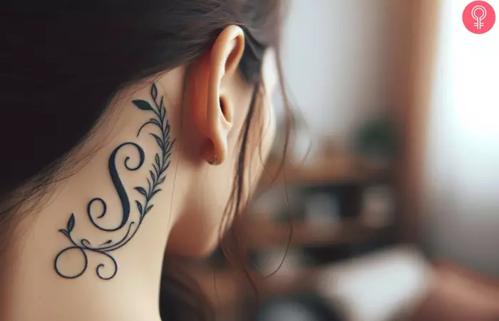Woman with letter S tattoo behind ear