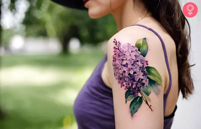 Lilac flower tattoo on the upper arm