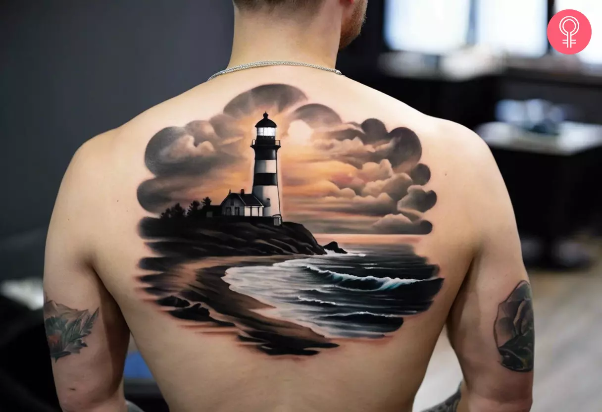 Man with a realistic lighthouse tattoo on his upper back