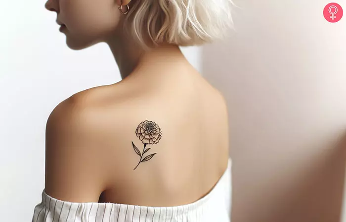 Outline marigold tattoo on the shoulder