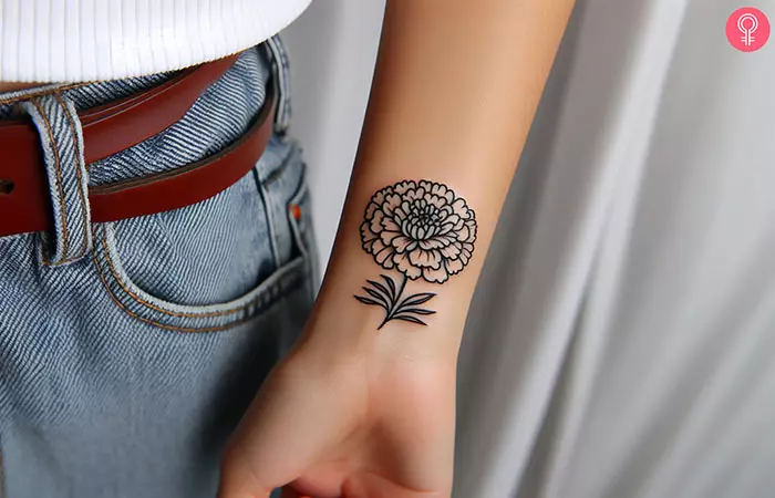 traditionally drawn colorful marigold tattoo on the wrist