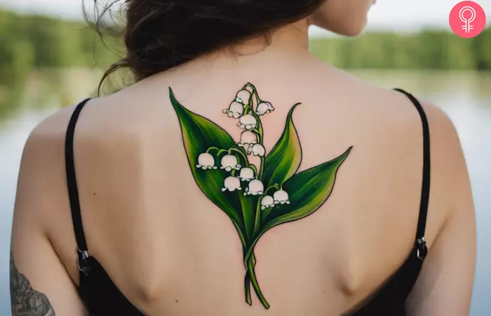 Lily of the Valley birth flower tattoo on the upper back