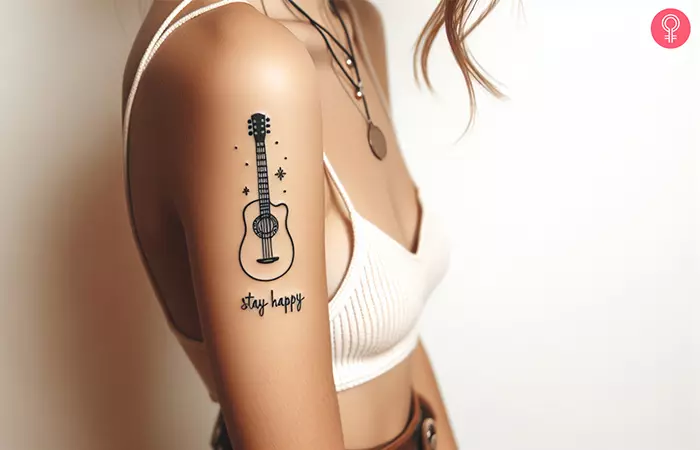 Meaningful guitar tattoo on the upper arm