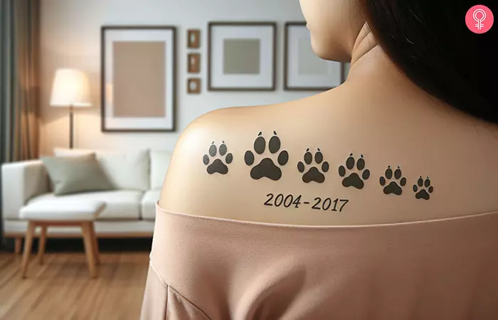 A memorial paw print tattoo on the shoulder 