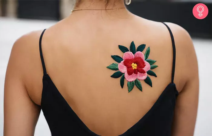 Embroidery tattoo on the upper back
