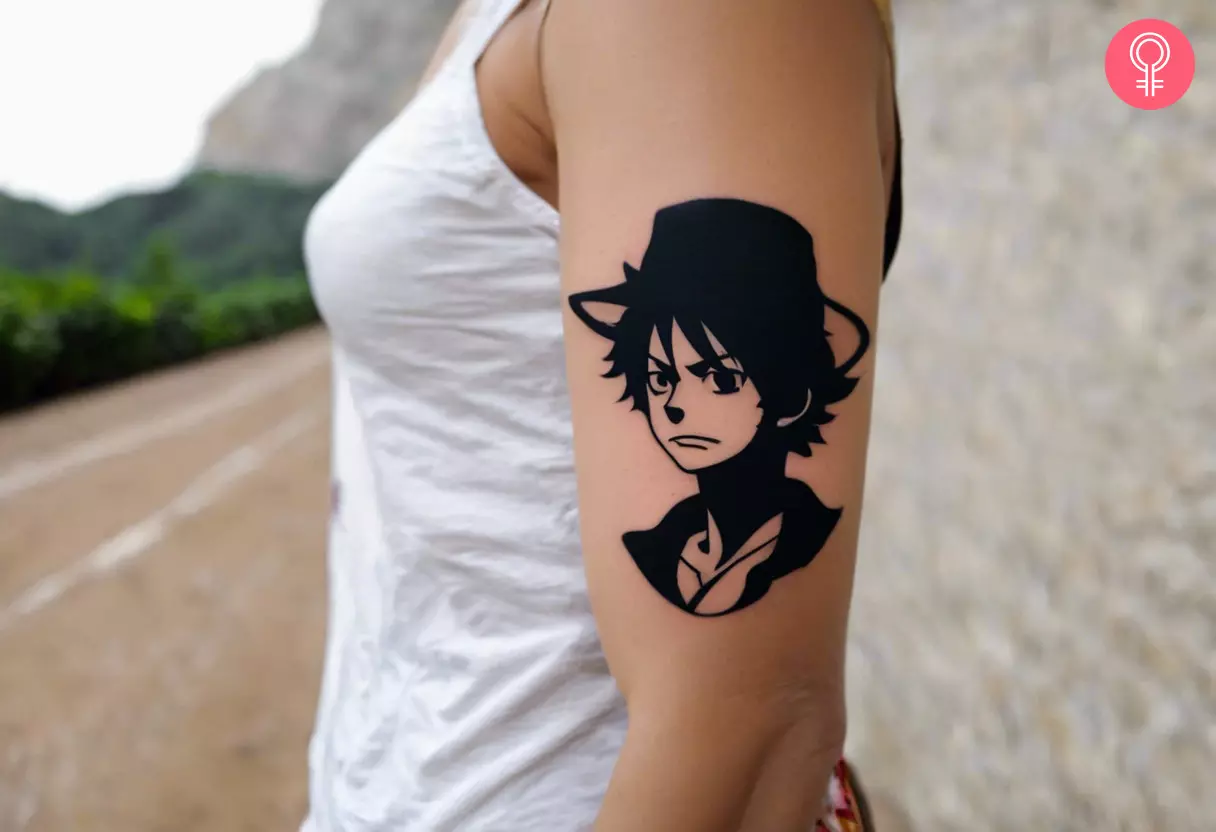 Minimalist One Piece tattoo on a woman’s arm