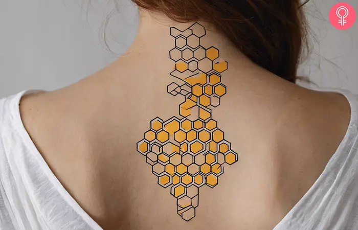 Minimalist honeycomb tattoo on the back of the neck
