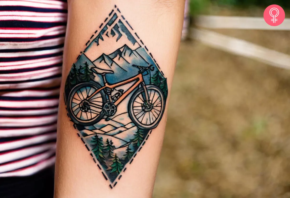 A traditional forearm tattoo of a mountain bike