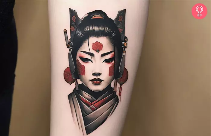A woman with a realistic ninja geisha warrior tattoo on her forearm