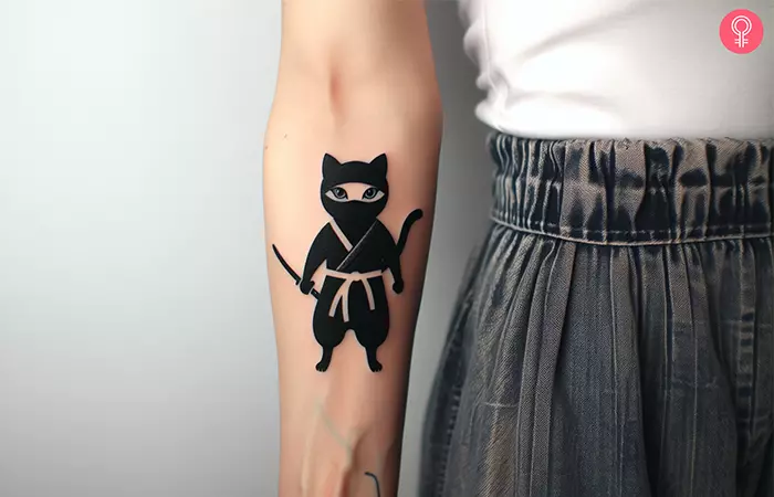 A woman with a ninja cat drawn on her forearm