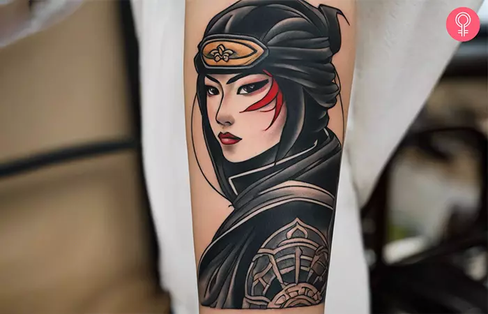 A woman with a Japanese ninja tattoo on her forearm