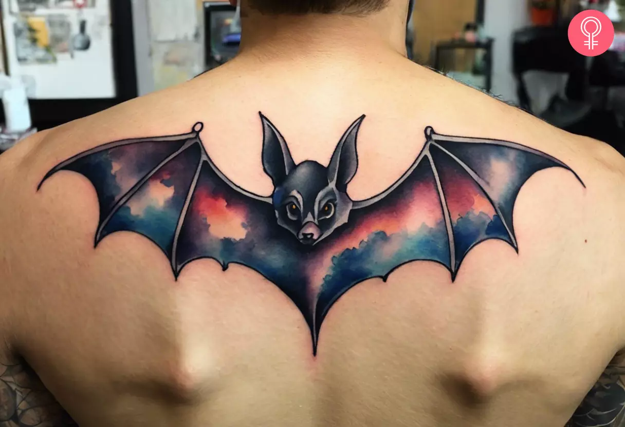 An old school bat tattoo on a man’s back