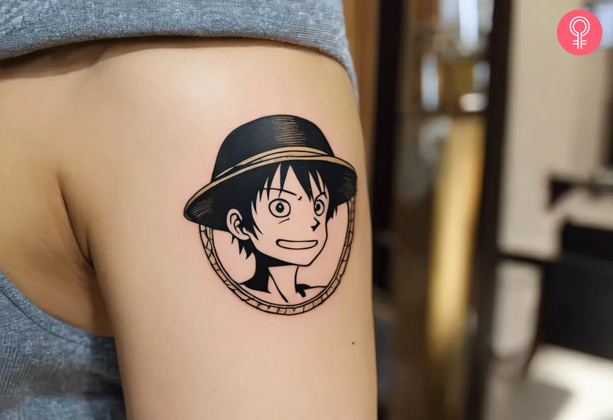 One Piece straw hat tattoo on a woman’s arm