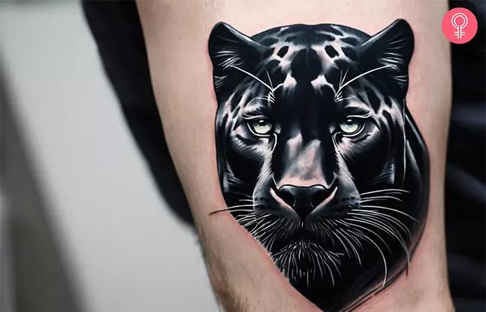 Panther head tattoo on the upper arm