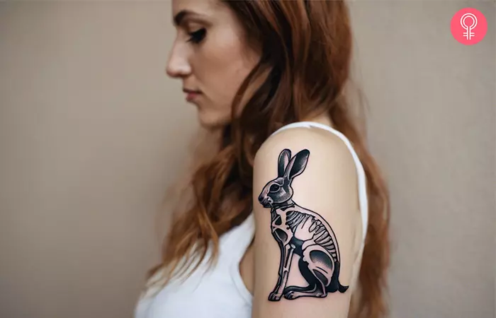 A woman with a rabbit skeleton tattoo on the back