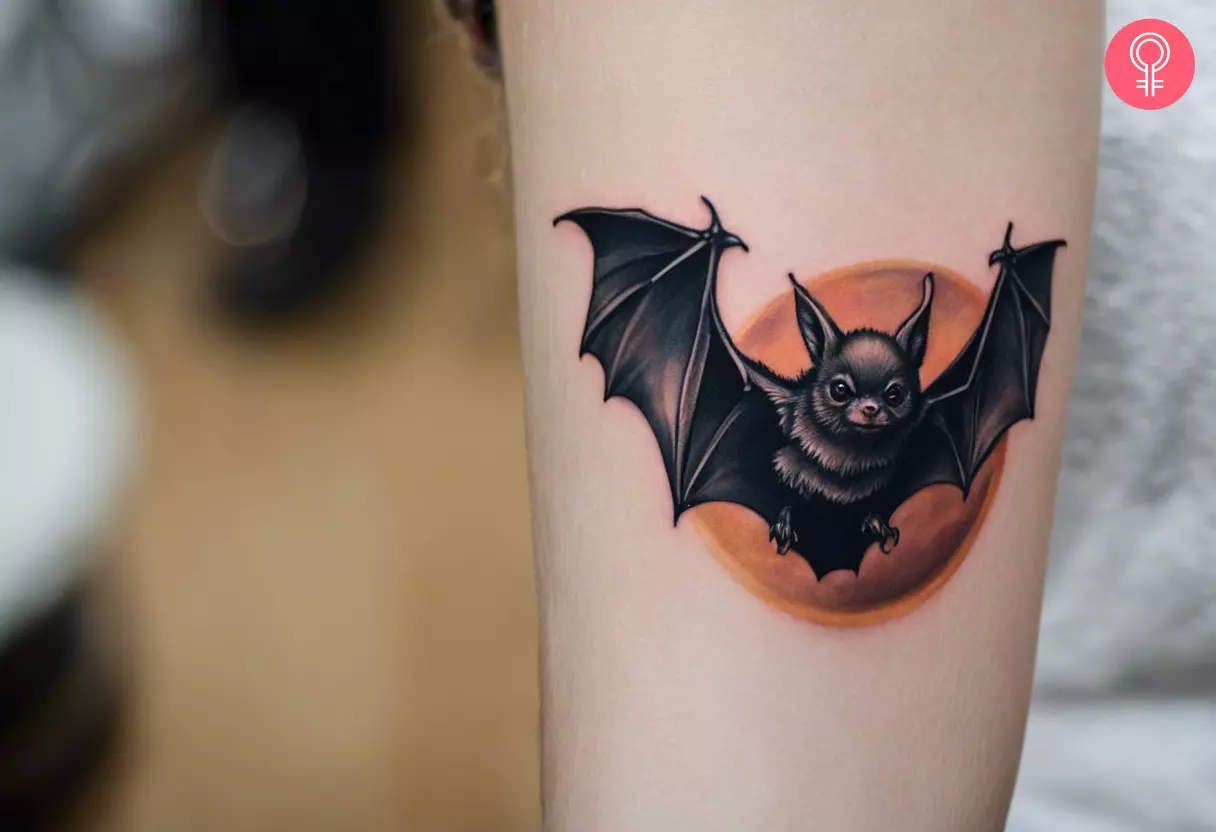 A flying bat tattoo on a woman’s forearm