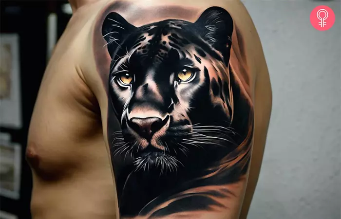Realistic panther tattoo on the upper arm