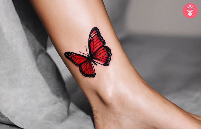  A woman with a red and black butterfly tattoo on her ankle