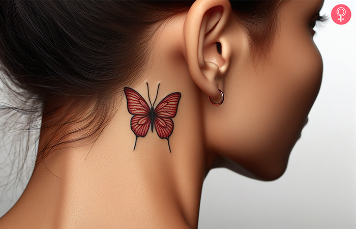 A woman with a red butterfly tattoo behind her ear