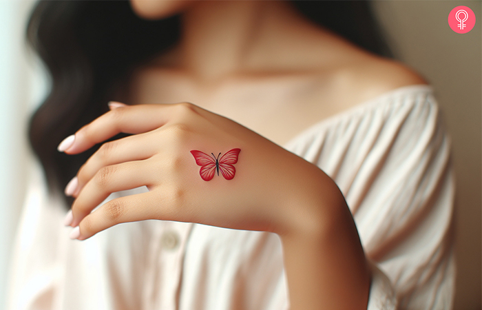 Woman with a red butterfly hand tattoo