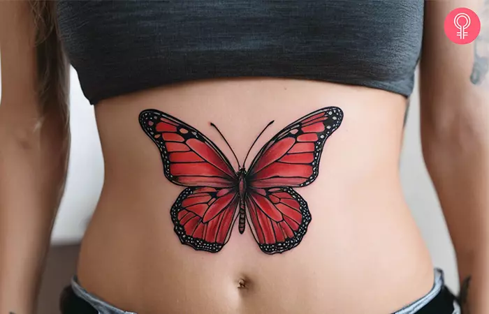 A woman with a red butterfly tattoo on her stomach
