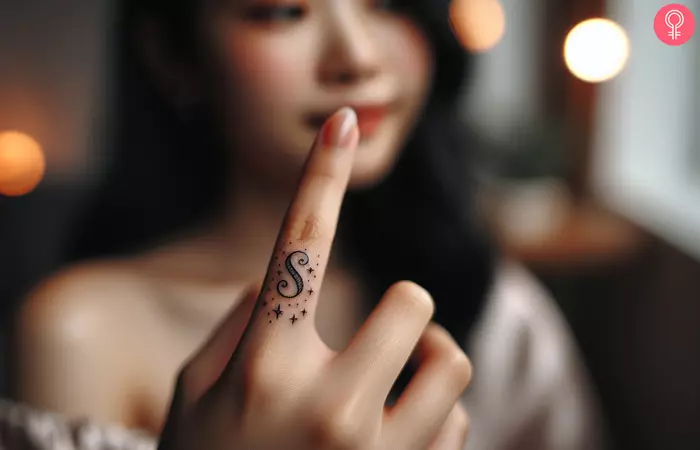 woman with S Letter Tattoo On Finger