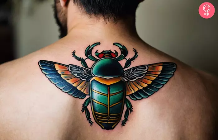 Scarab beetle tattoo on the back shoulder