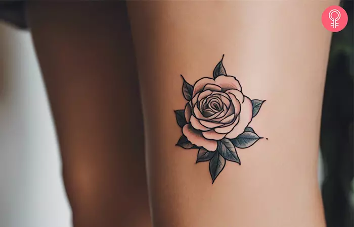A simple above knee tattoo of a rose