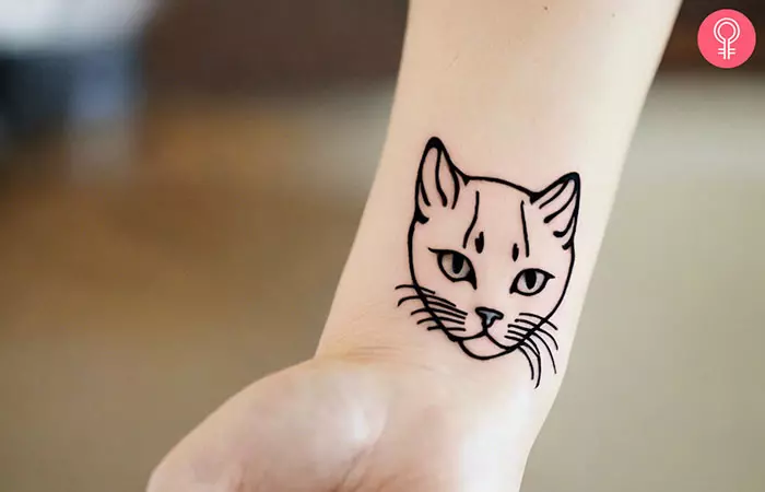 A simple cat tattoo on the forearm
