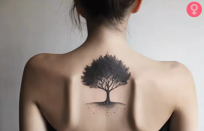 Dotwork tattoo of a tree on a woman’s back