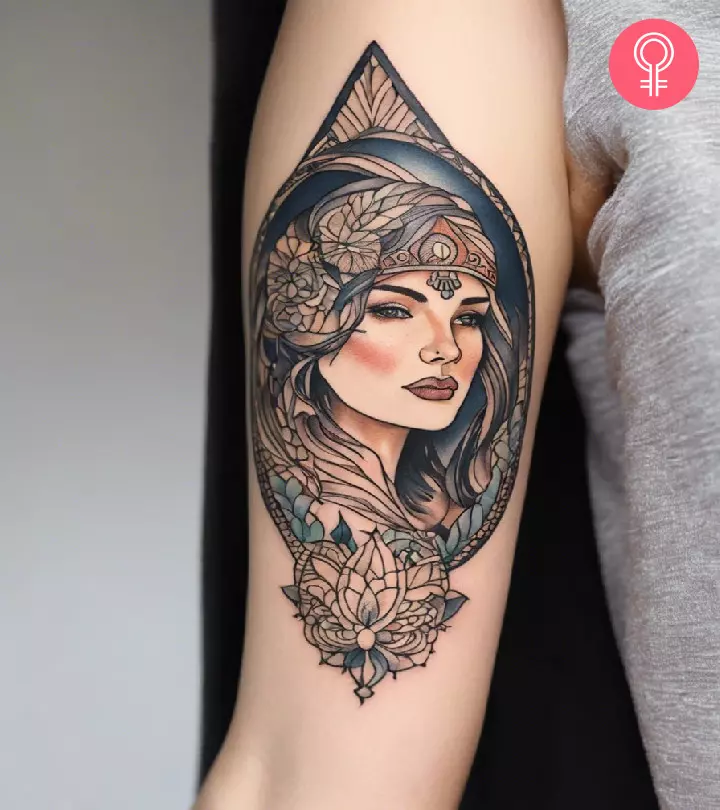 A tattoo of a woman’s portrait on the inner bicep