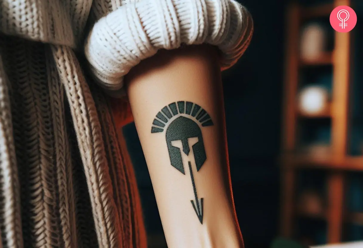 Simple Spartan helmet with an arrow tattoo on the forearm