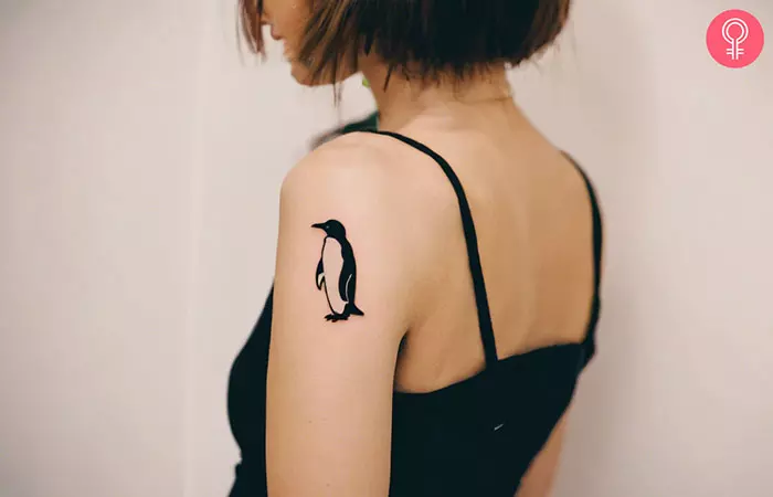 Simple penguin tattoo on the upper arm