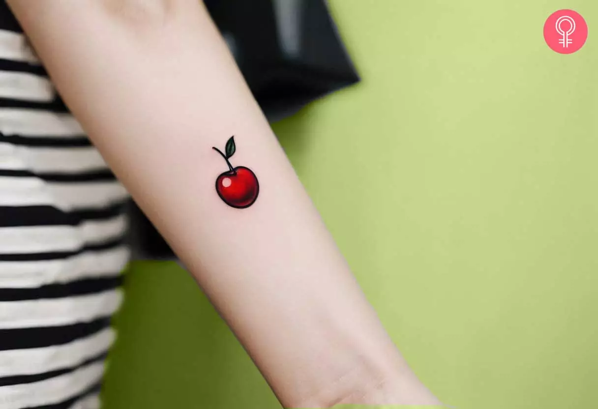 Small cherry tattoo on arm