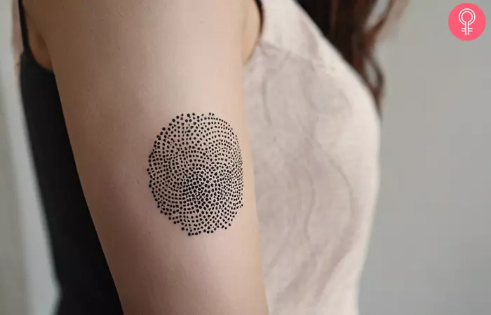 dotwork helix ball tattoo on a woman’s upper arm