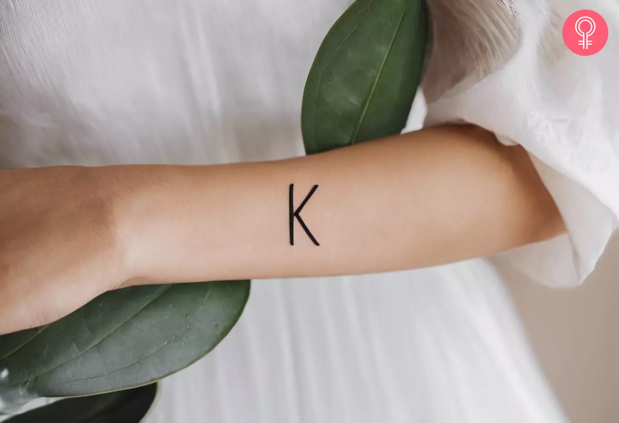A letter K tattoo on the forearm