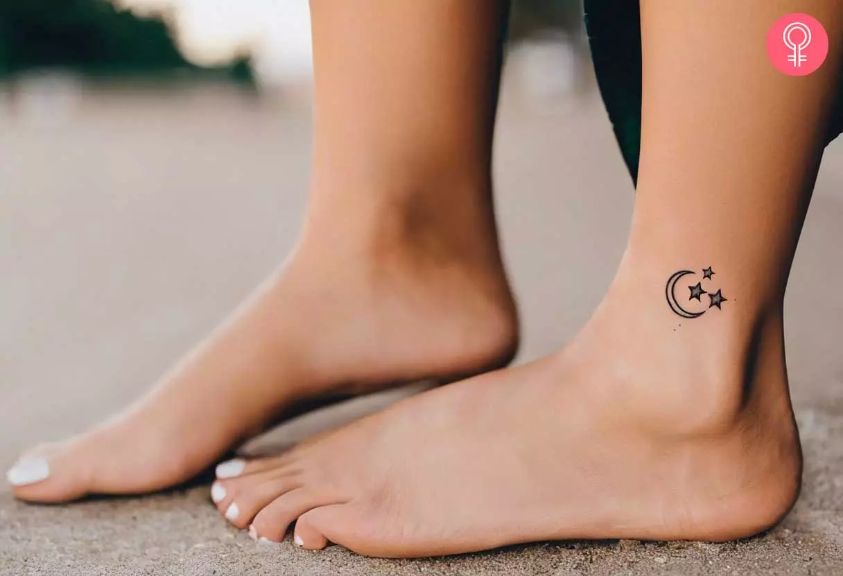 A small tattoo showing the moon and stars tattoo on the ankle