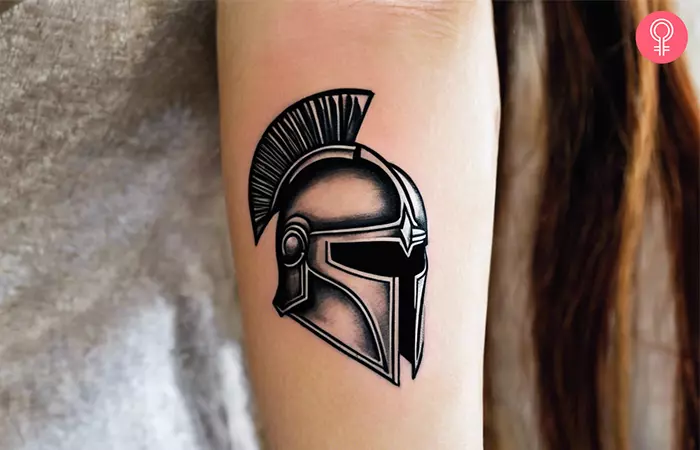 A small Spartan tattoo of a Spartan helmet