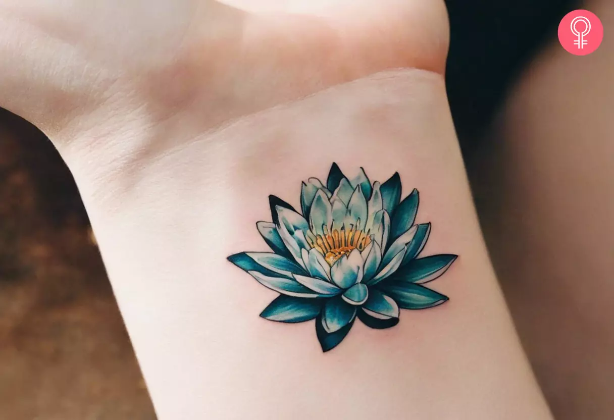A woman wearing a small water lily tattoo on her wrist