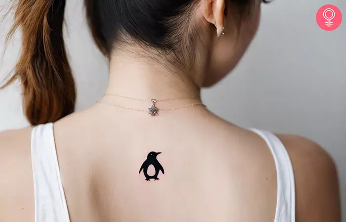Small penguin tattoo on the back